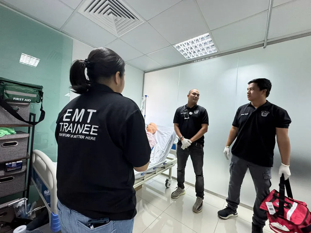 EMT trainee and instructors practising around a training mannequin at MMT, Abu Dhabi